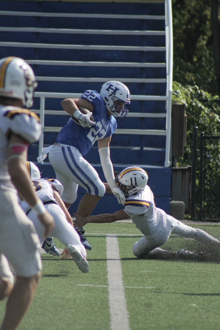 Tayden Lorenzen (10) runs the ball and dodges a Campbell County player.